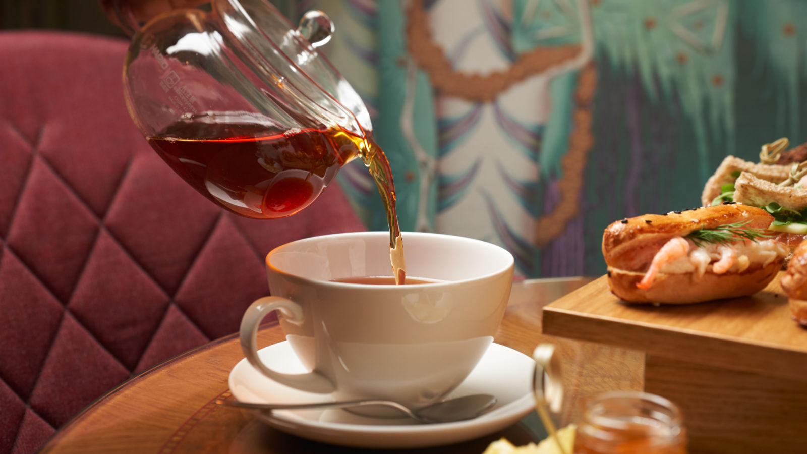 Pouring tea into a cup at Hotel St. George Wintergarden
