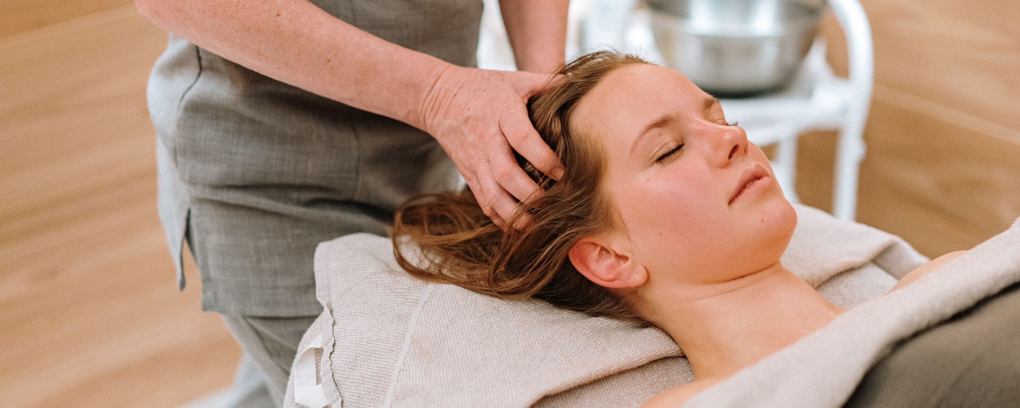 Massage relax studio. Woman having her neck massaged by a