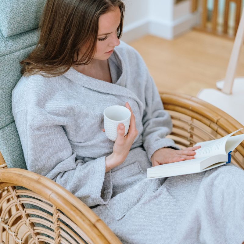 A girl sitting in St. George Care Spa reading magazine